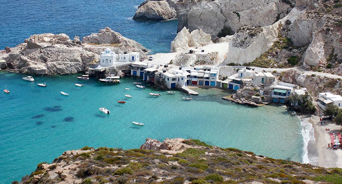 Picturesque coastline of the fishing village of Klima with light blue water and Mediterranean flair.